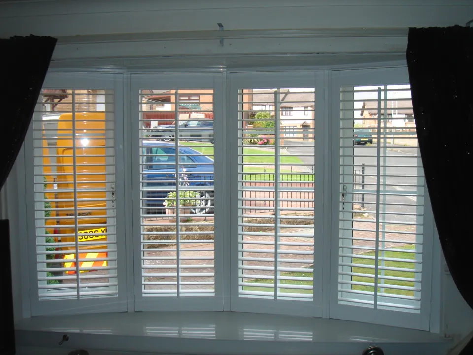 Full-height wooden shutters fitted by a time-served joiner in a Glasgow bedroom